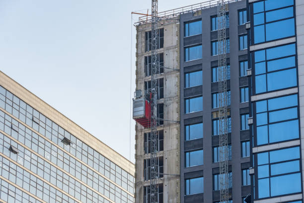 istock Construction elevator outside the facade of a multi-storey building under construction. 1301793326