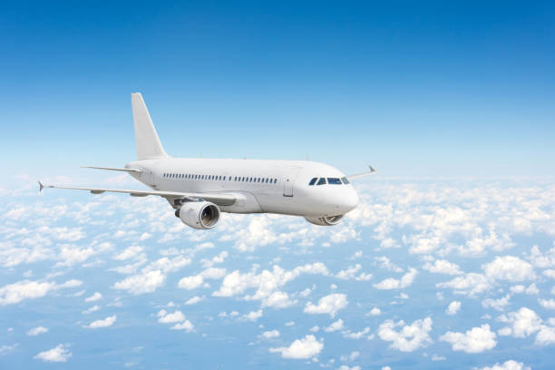 istock Airplane fly over the clouds and the earths surface under the blue sky. 1301793440