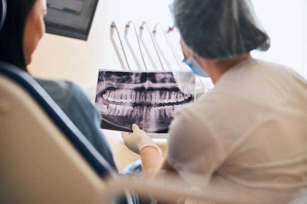 istock Focused photo on dentist that talking to patient 1301795614
