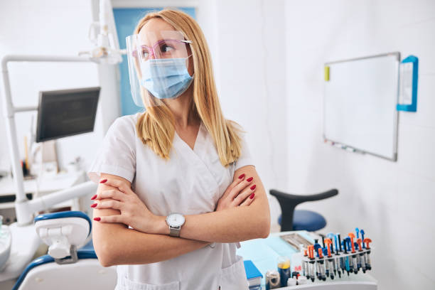 istock Young dentist waiting for the patient for teeth whitening 1301795649