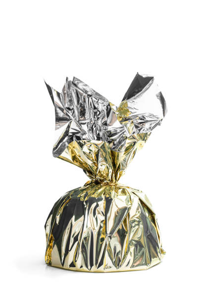 istock Gifting Christmas pudding wrapped in golden foil isolated on white background 1301796240