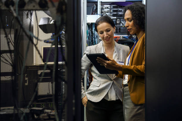 istock IT professionals having meeting in server room 1301796579