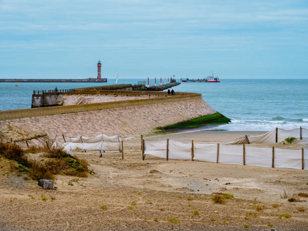 istock View towards pier and Lighthouse guarding harbour entrance 1301801000