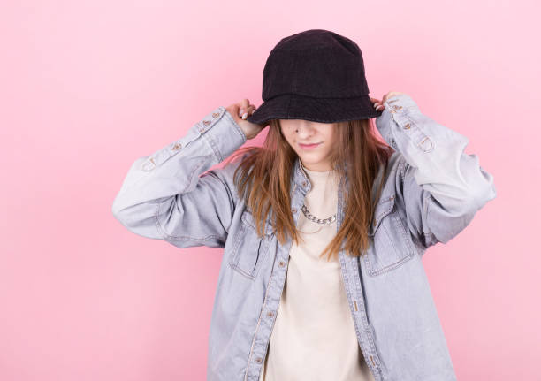 Fresh summer girl in denim shirt and black panama hat. Party monochrome vanilla style. Minimal design trends Fresh summer girl in denim shirt and black panama hat. Party monochrome vanilla style. Minimal design trends bucket hat stock pictures, royalty-free photos & images