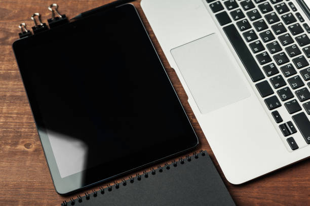 istock electronic gadgets and office supplies on wooden table 1301802526