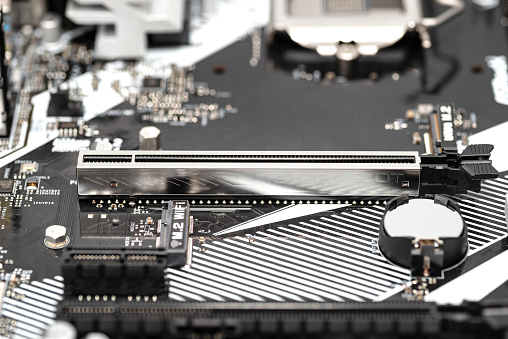 A macro shot of a PCI Express 3.0 x16 steel slot connector on a modern desktop motherboard.