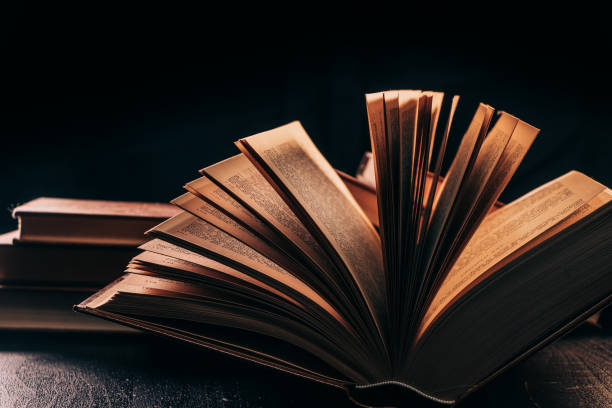 istock an antique book open on a wooden table 1301805321