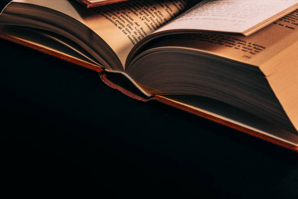 istock antique book open on a wooden table 1301805326