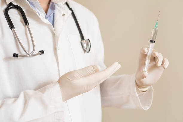 istock Male doctor showing  injection 1301805350