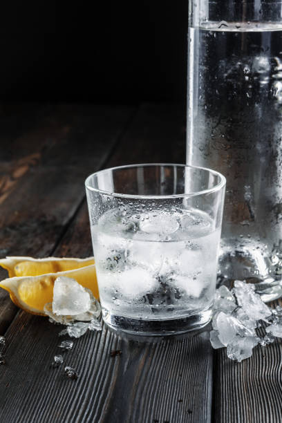 istock Vodka in shot glasses on rustic wood background 1301806904