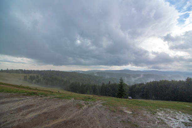 istock Dark rain clouds over highlands valley. Nature mountain lanscape 1301808211