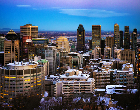Elevated view of the downtown Montreal skyline at blue hour on a Winter evening, Photographed on the Mont-Royal looking towards the Victoria bridge.