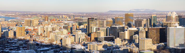 Panoramic Elevated view of the downtown Montreal skyline on a clear Winter day. Photographed on the Mount-Royal looking towards the Mont Saint-Bruno.