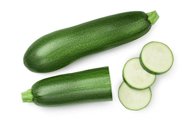 istock Fresh whole and sliced zucchini isolated on white background with clipping path and full depth of field. Top view. Flat lay 1301815361