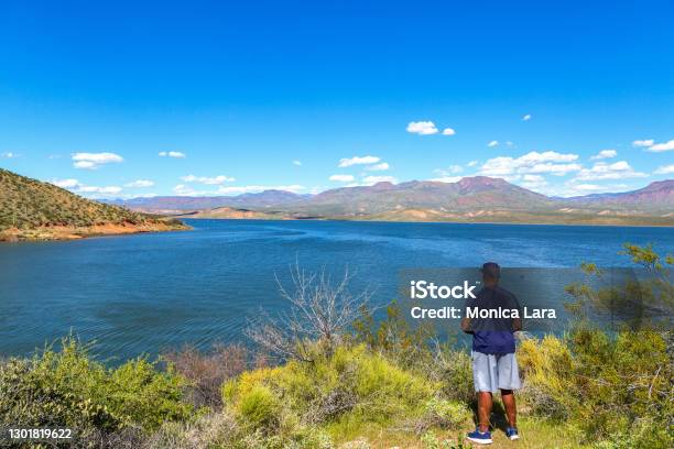 African American Man Looking At Roosevelt Lake In The Arizona Desert Stock Photo - Download Image Now