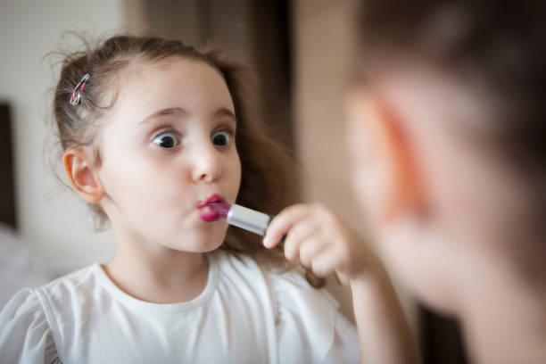 istock Little girl's first lipstick 1301822331