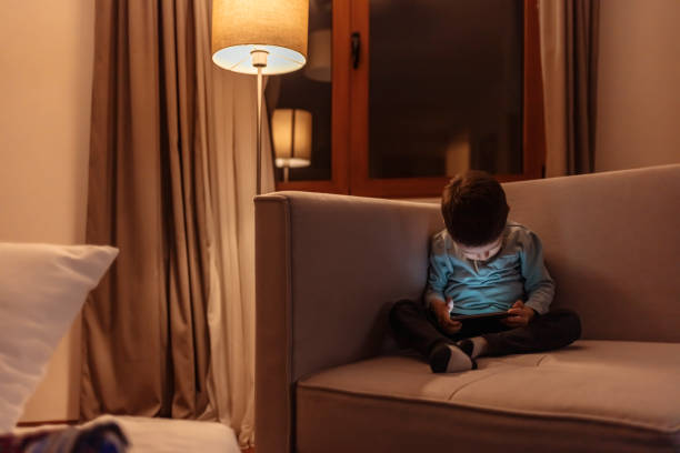 istock Boy watching movie on digital tablet 1301824266
