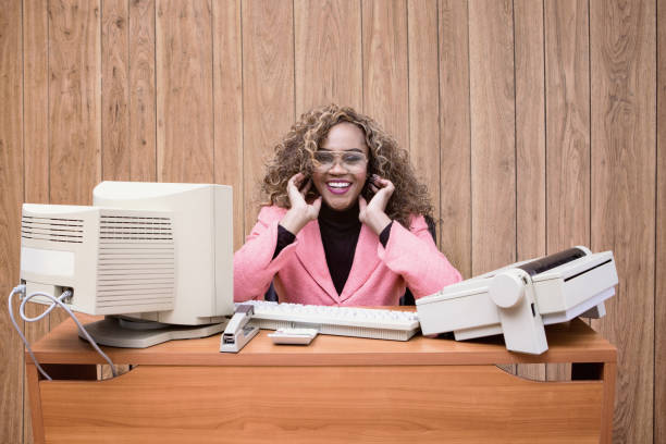 Businessman at a messy desk, mess everywherelots of documents, coffee cup on keybord knows his business.