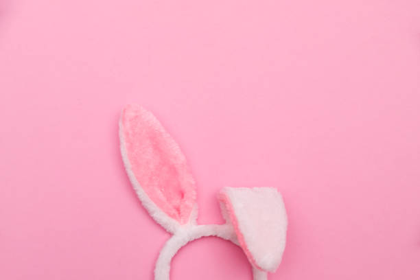 istock Easter bunny. Happy Easter holiday background concept.Flat lay colorful bunny egg with accessory to celebration on modern rustic pink pastel paper at home office desk. 1301826561