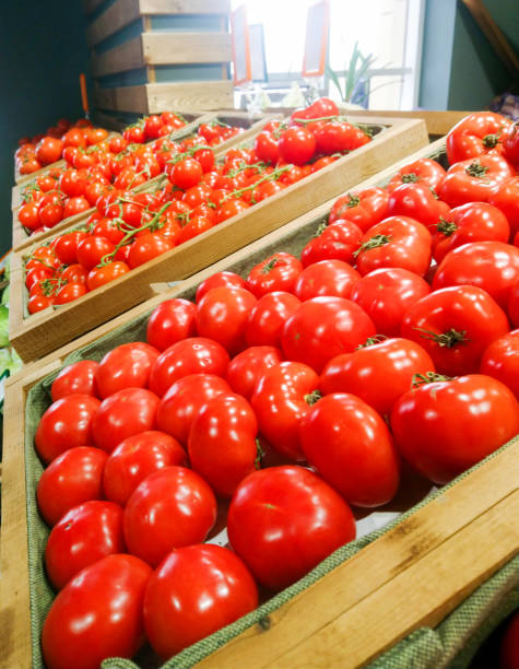 Ripe red and pink tomatoes on the counter at the vegetable market or in the store