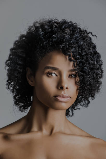 istock Beautiful young black female posing for studio headshot 1301832196