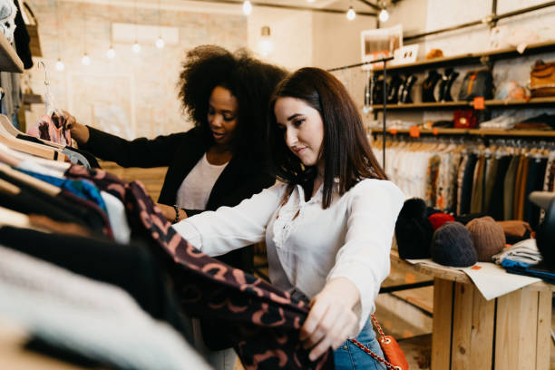 istock Friends going shopping together in a small shop 1301833077