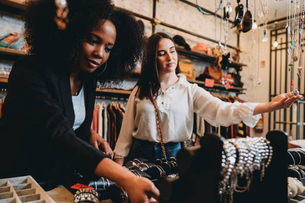 istock Two friends going shopping together in a small store 1301833088