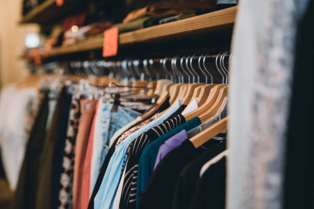 istock Many clothes hanging in a shop 1301833117
