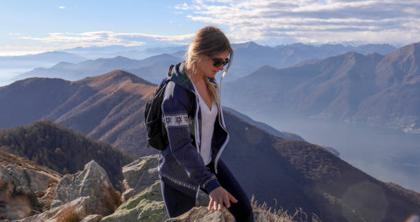 istock Female hiker walks along sunny mountain ridge 1301833325