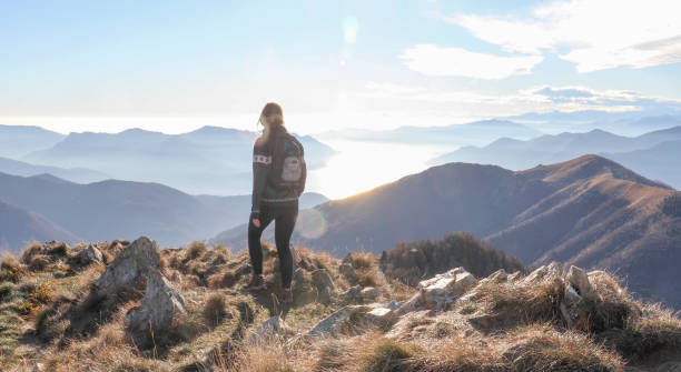 istock Female hiker walks along sunny mountain ridge 1301833377