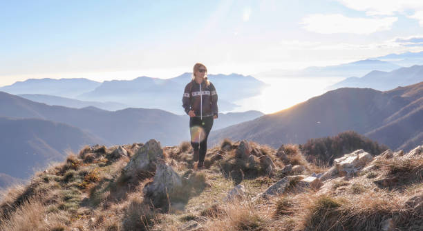 istock Female hiker walks along sunny mountain ridge 1301833389