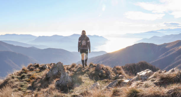 istock Female hiker walks along sunny mountain ridge 1301833458