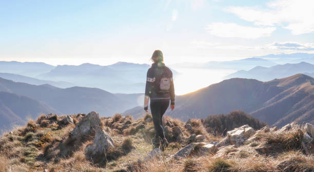 istock Female hiker walks along sunny mountain ridge 1301833460