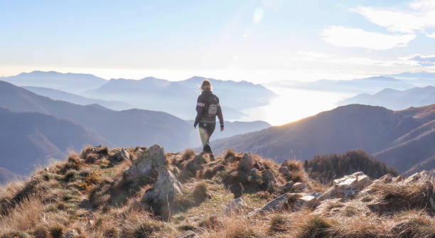 istock Female hiker walks along sunny mountain ridge 1301833462