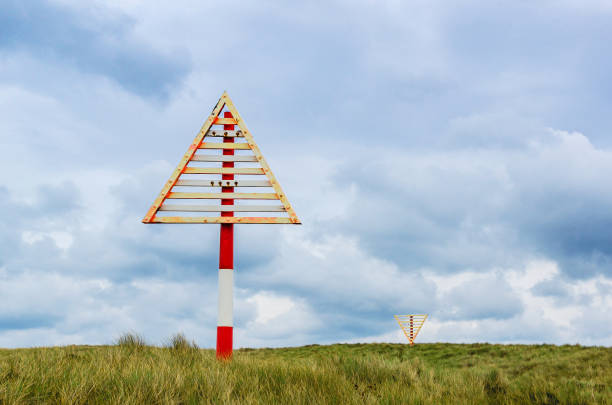 Navigation mark on the sand dunes of the coastline of the Island Sylt, near List, Ellenbogen, Germany.