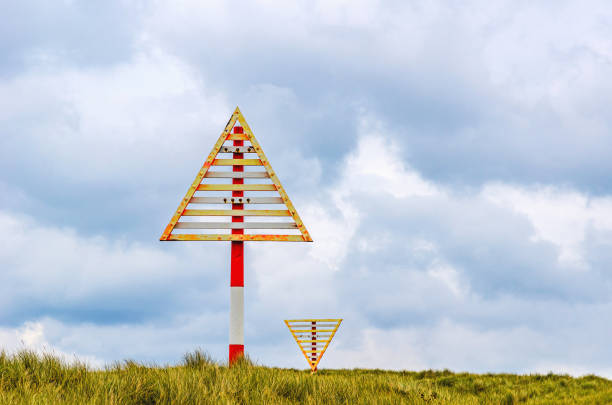 Navigation mark on the sand dunes of the coastline of the Island Sylt, near List, Ellenbogen, Germany.