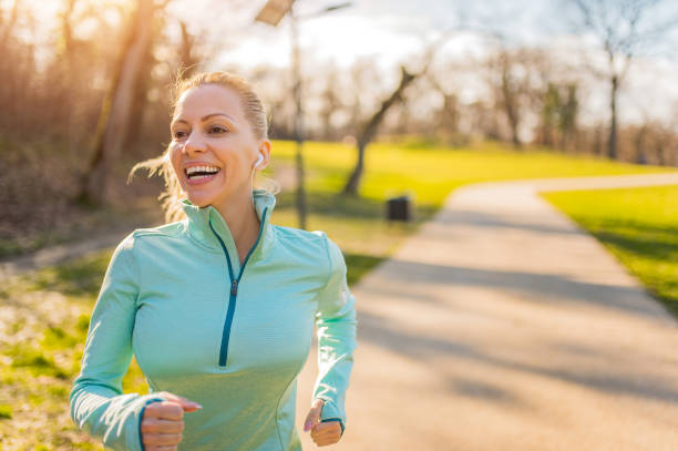 istock Young woman running in the park. 1301834512