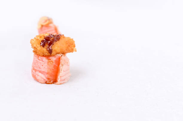 istock Sushi rolls with salmon avocado and fried shrimp on a white background. 1301835653