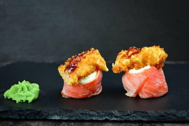 istock Delicious sushi rolls with salmon avocado wasabi 1301835771
