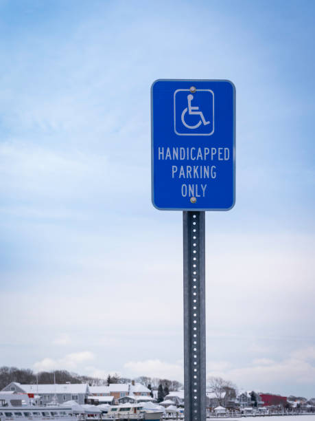 istock Handicapped Parking Only Sign on Blue Cloudy Sky Background 1301835879