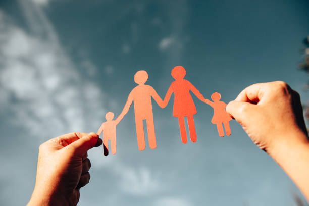 istock holding a family paper doll 1301840270