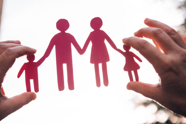 istock holding a family paper doll 1301840288