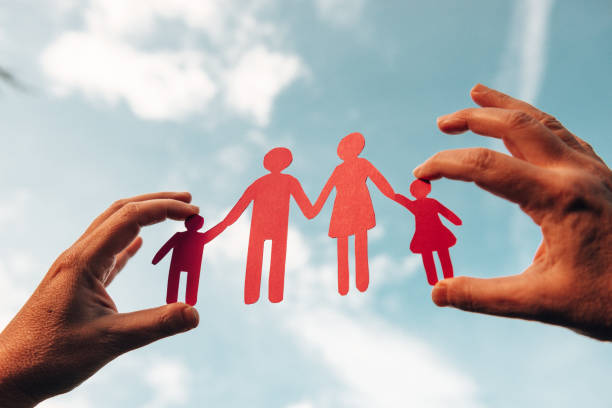 istock holding a family paper doll 1301840352