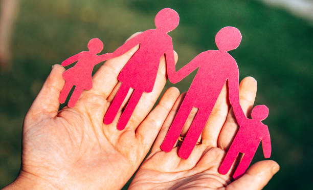 istock holding a family paper doll 1301840382