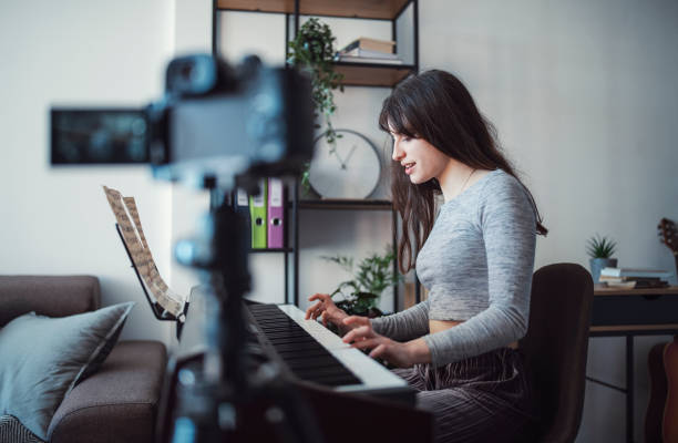 istock Young female musician recording her piano performance. 1301841131