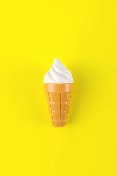 istock Close-up of a plastic ice-cream on yellow background. 1301841493