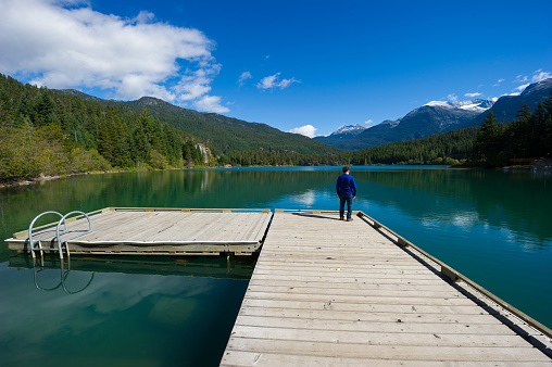 Whistler Canada in Summer. Dock at Green Lake. Top travel destinations in Canada. Senior exploring nature.
