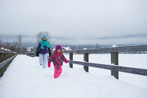 Enjoying a snowy Valley Trail in Whistler, BC. Family bonding outside in winter.