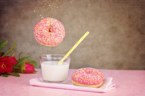 istock Pink donut with a glass of milk 1301843205