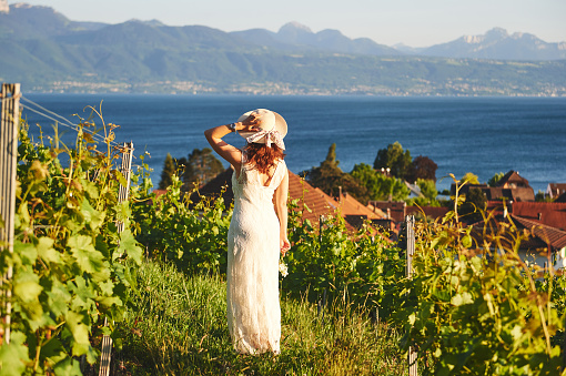 Woman enjoying nice view on Lake Geneva from Lavaux vineyards, Lausanne, Canton of Vaud, Switzerland